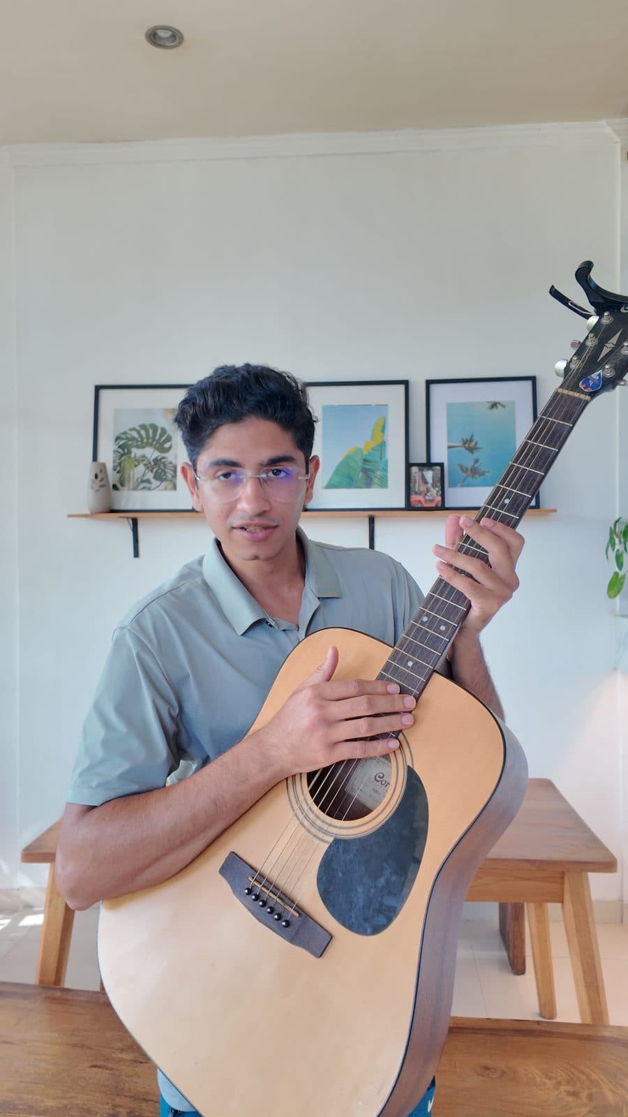 Strumming a guitar, close-up in glasses — off the clock